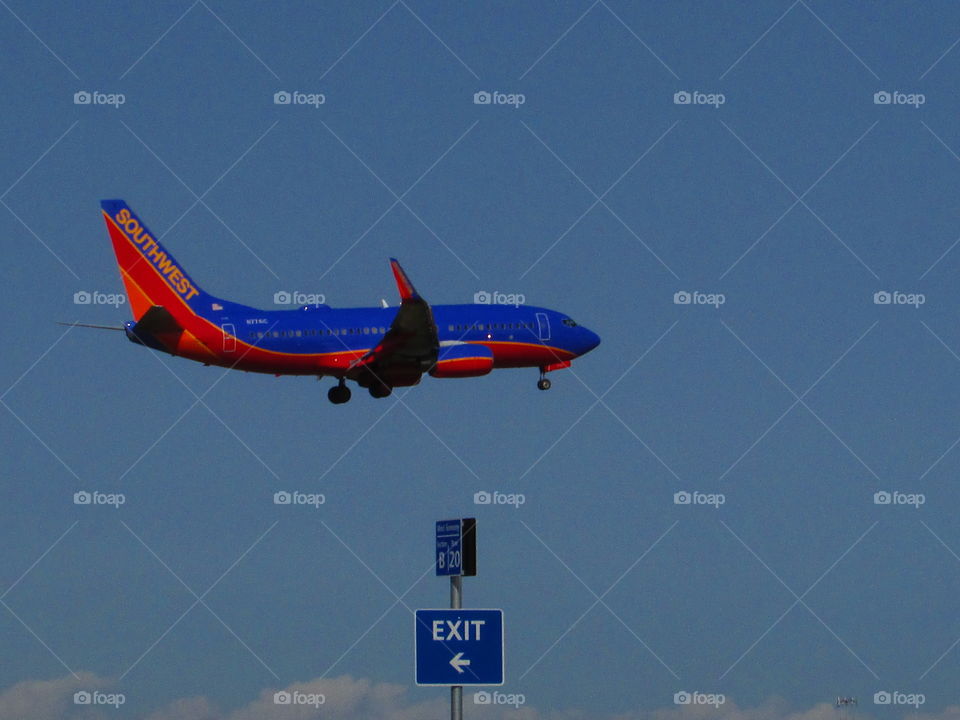 airplane exit sign, airplane coming in for a landing