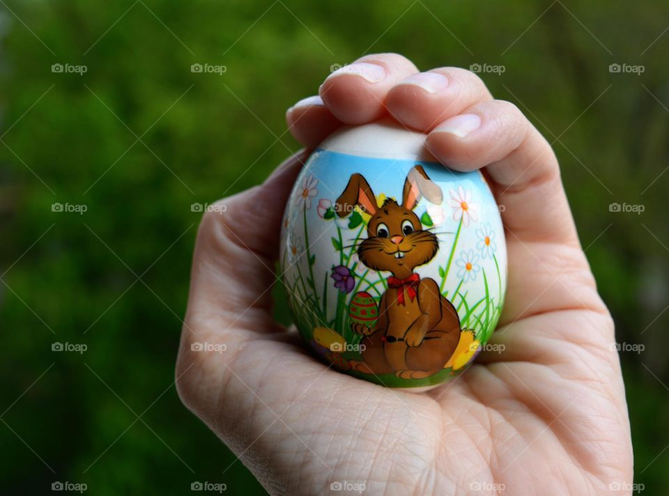 Easter egg in the hand spring holiday