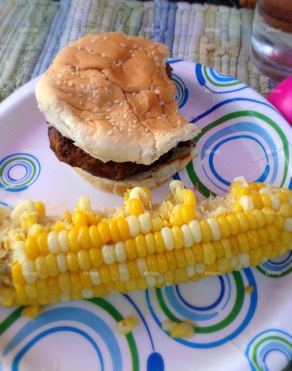 Eat up! . Corn on the cob and a burger - yum!  It's barbecue time mission 