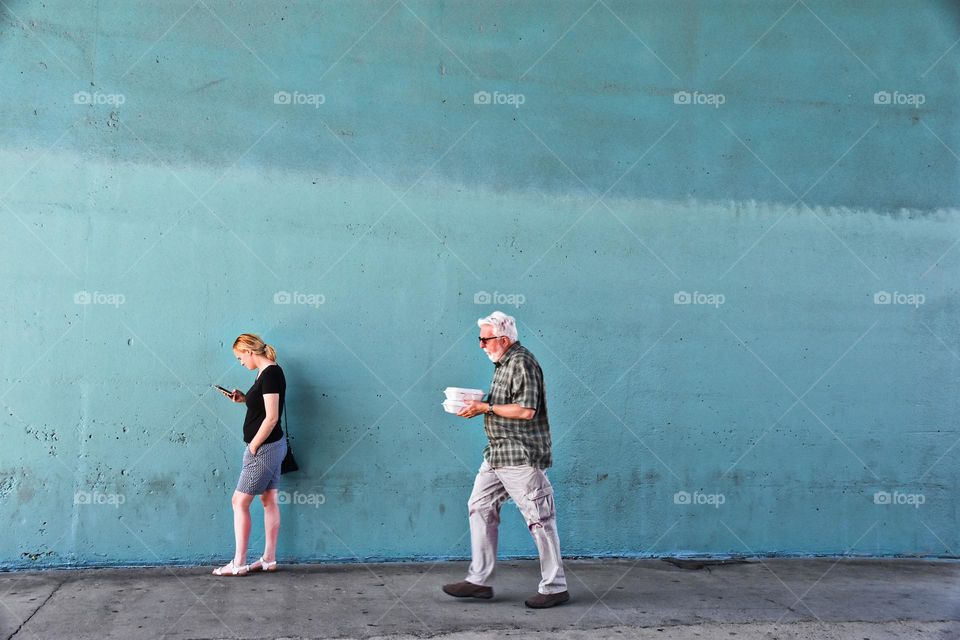 Young woman and older man going back to work during lunch break 