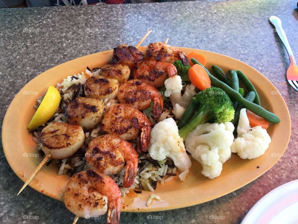 Shrimp and scallops on wild rice with vegetables