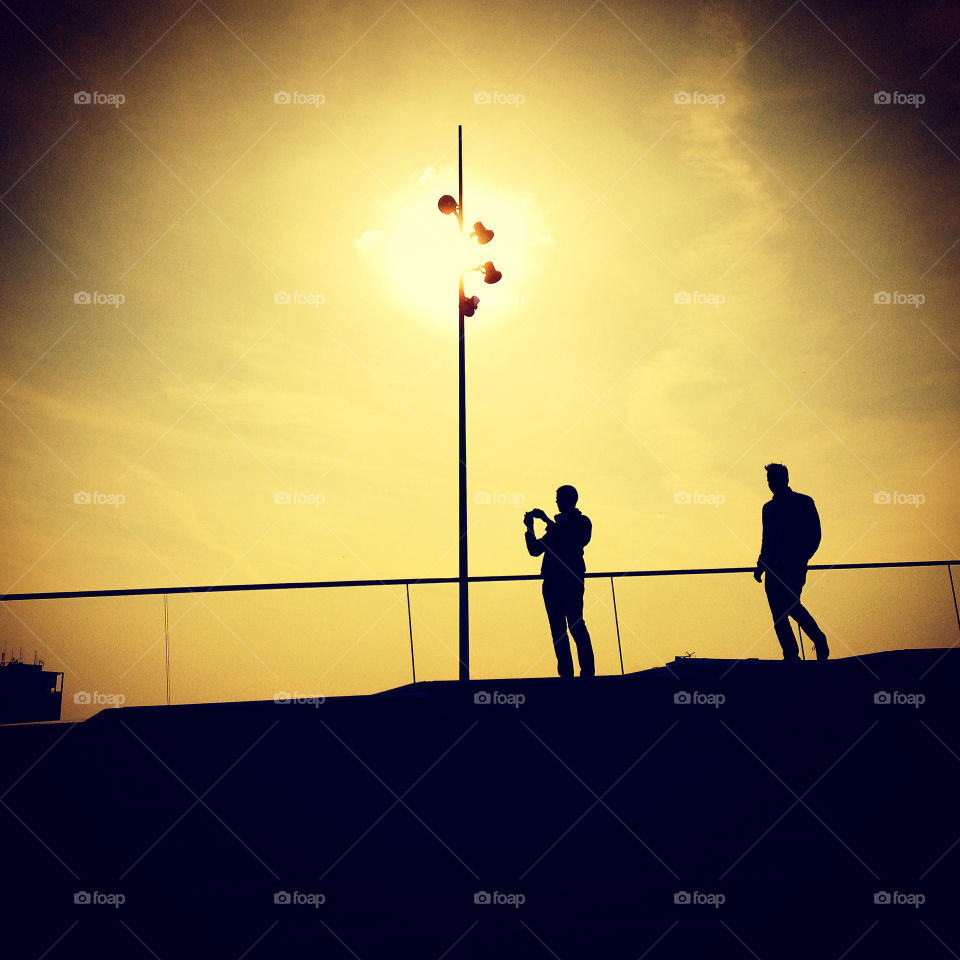 Silhouette of two men at sunset