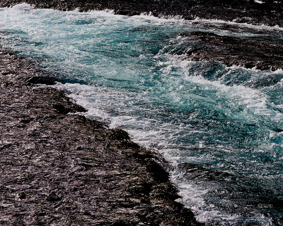 Wizard Falls on the Metolius River in Central Oregon show off their rich blue water in a channel on a cold winter day. 