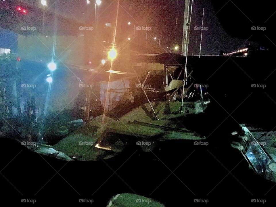 The “yachts” at “Newtown Creek” beneath the “Pulaski Bridge” receive their nighttime illumination from the spotlights of the boats surrounding them. However faint they suffice. 2022. Hypnotic Productions