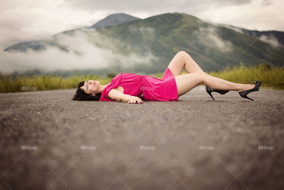 Beautiful woman lying on road
