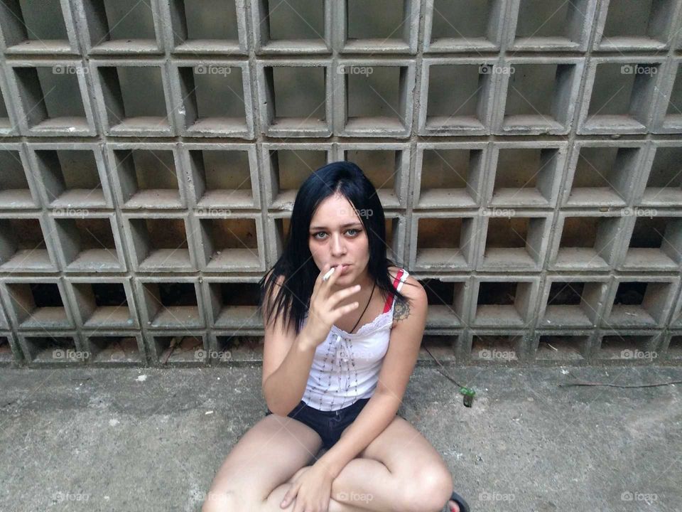 Woman smoking in the street