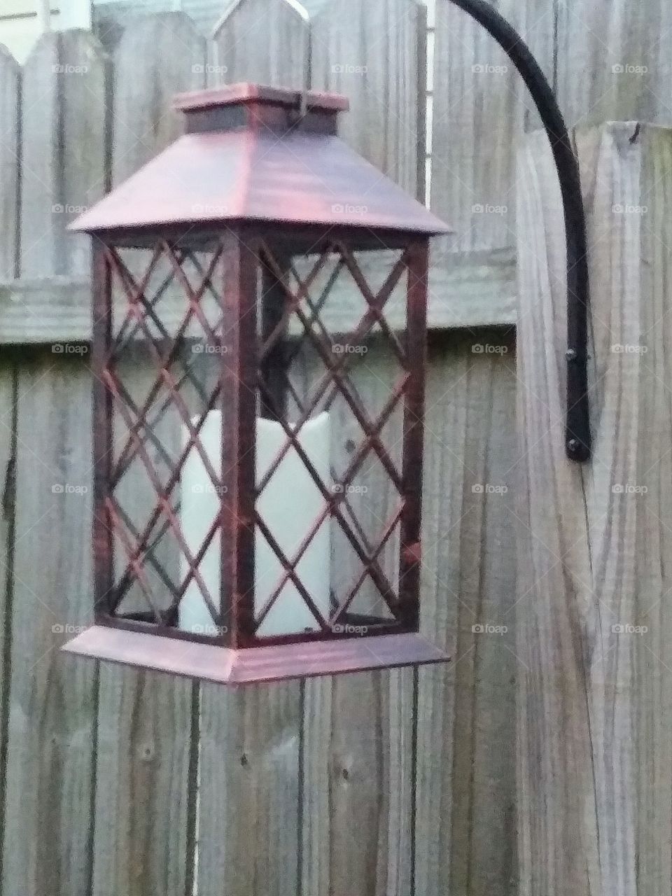 lantern attached to a fence post