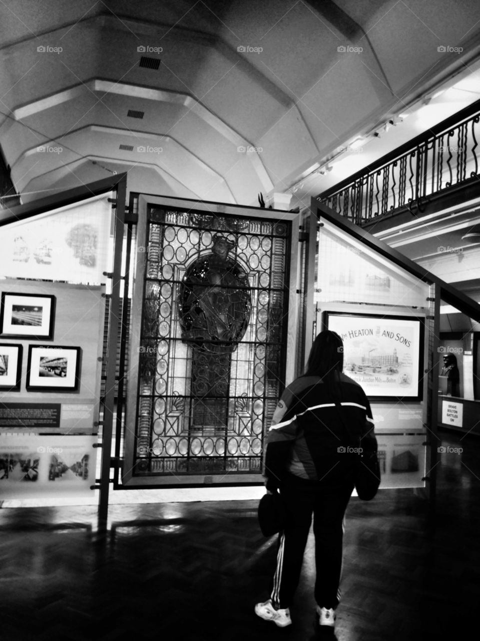woman looking at art in a museum in black and white