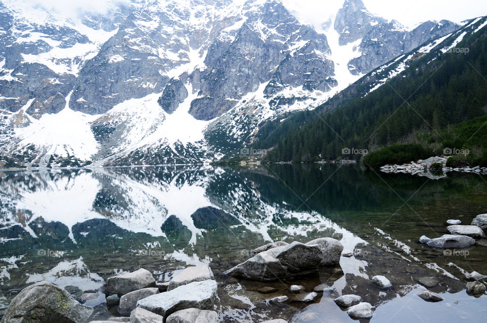 View of snowy mountain reflecting on lake