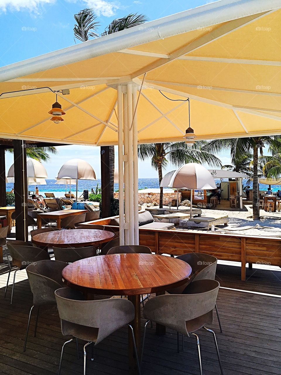 Outdoor seating on the beach of Curaçao.  Covered for shade from the sun, but otherwise all open to enjoy the beauty of your surroundings.