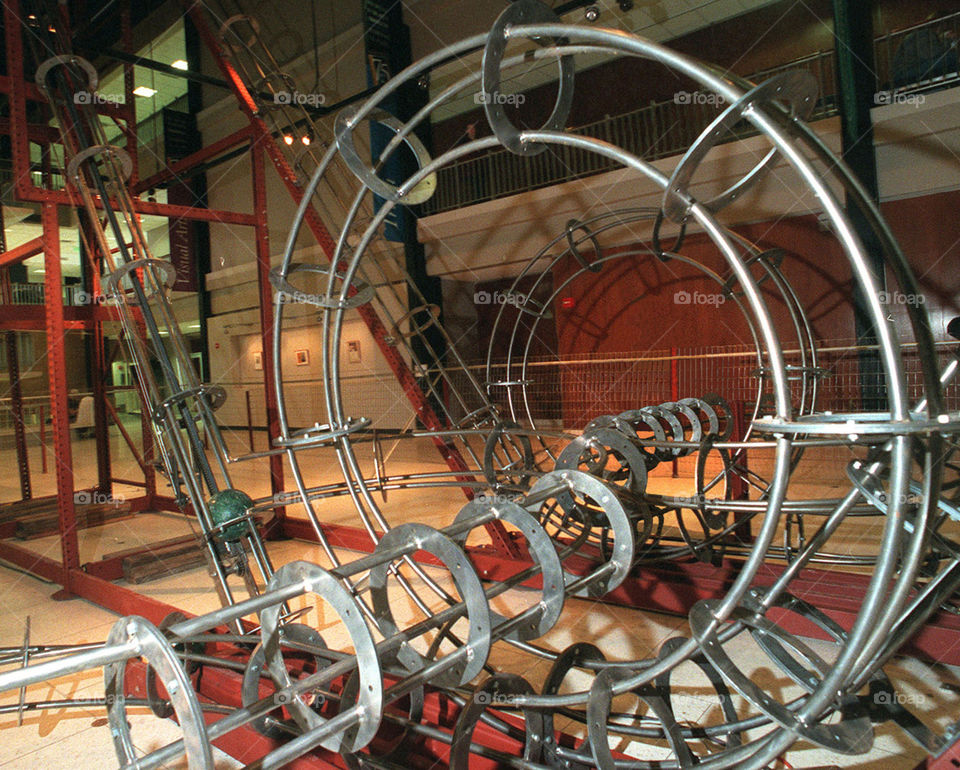 Sculpture I built that was installed in the Harris Fine Art Center at Brigham Young University.  Titled "The Bowler Coaster". It was 50 feet long, 20 feet wide and had over 200 ft of track.  Conveyors would lift the bowling balls to the top of two story tall towers after which the balls would go through a series of 7ft loops and bank turns before starting up the towers again.