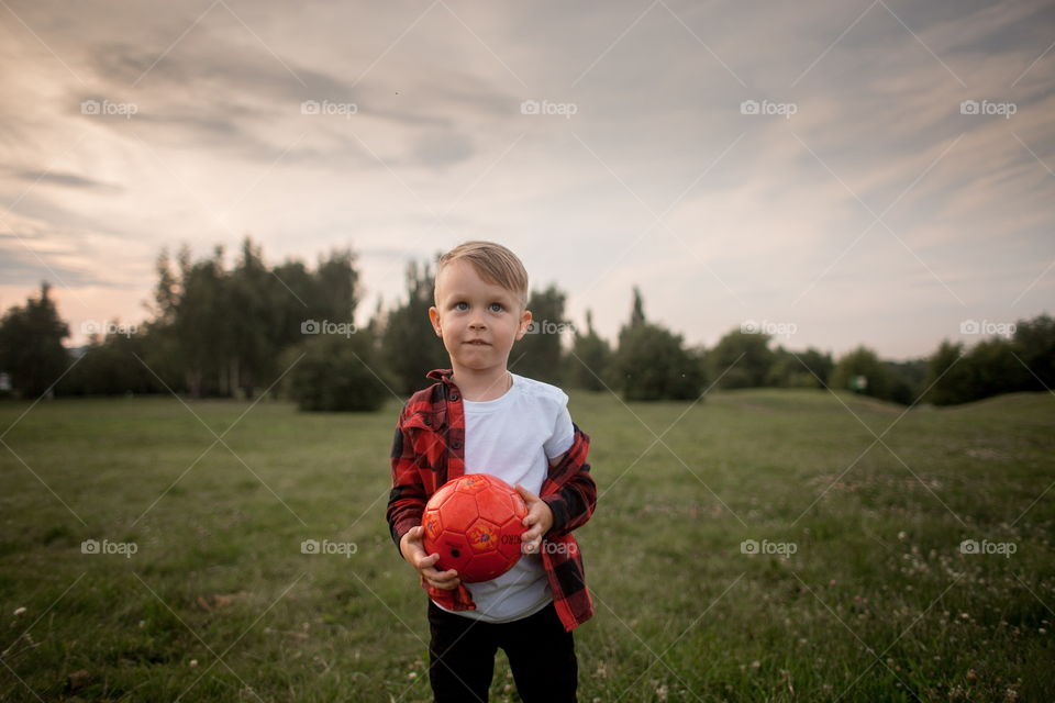 Little boy playing in soccer in a park 