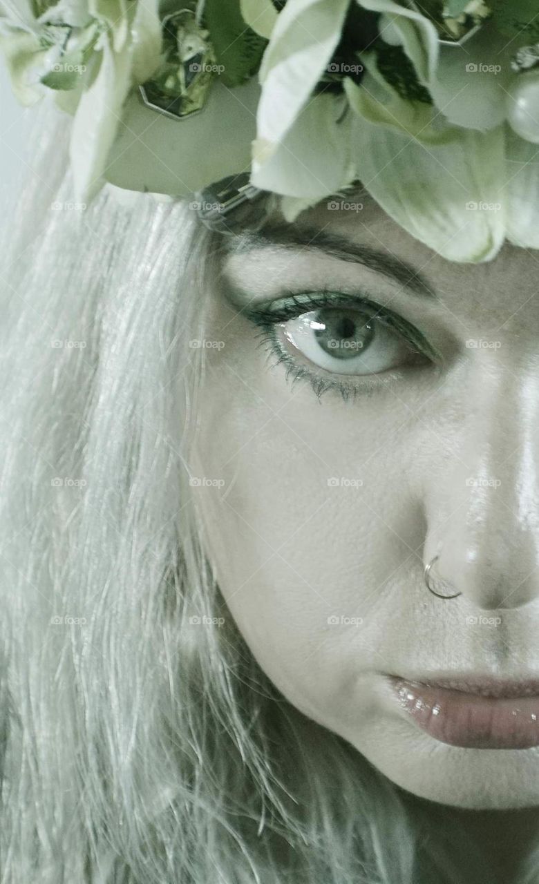 Art portrait woman wearing flower wreath face close up blonde model