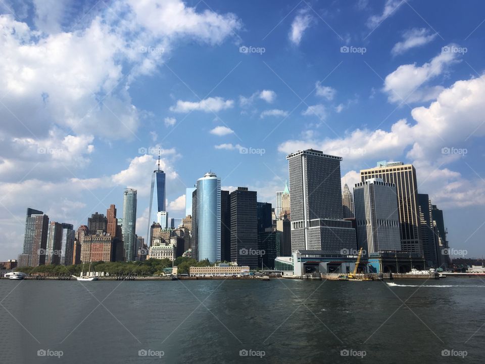 Low Manhattan, viewed from the ferry in a sunny day... New York, USA.