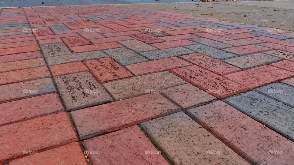 Writings in red brick on sidewalks 