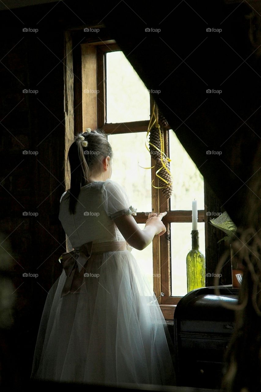 Girl looking out through the window