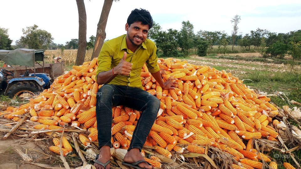 happy farmer with maize