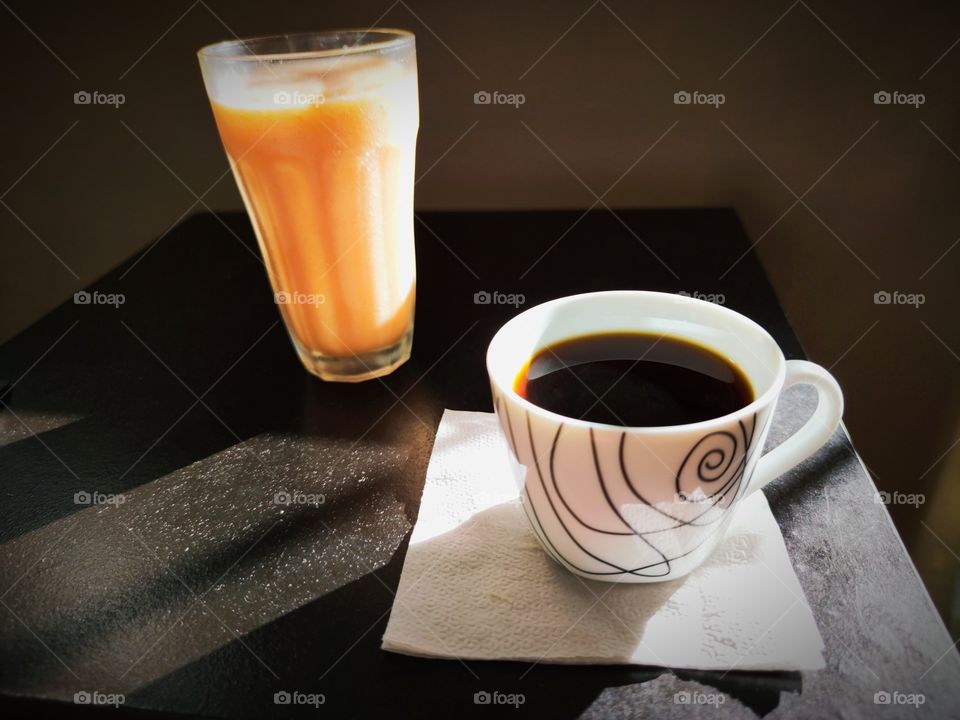 Cup of coffee with a papaya smoothie