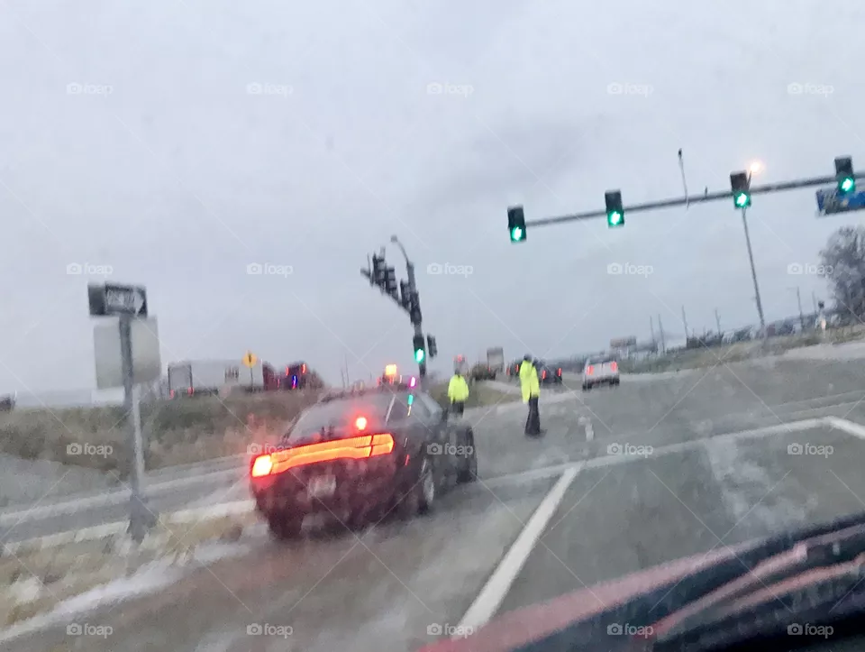 Police, Emergency Responders, Directing Traffic, Exit, Police Car, Lights and Sirens, a traffic Accident, high visibility, red, blue, flashing, traffic lights, green, light, ice, snow, weather, road, bridge, highway, intersection, arrows, lines, pavement, wet, slick, traffic, jam