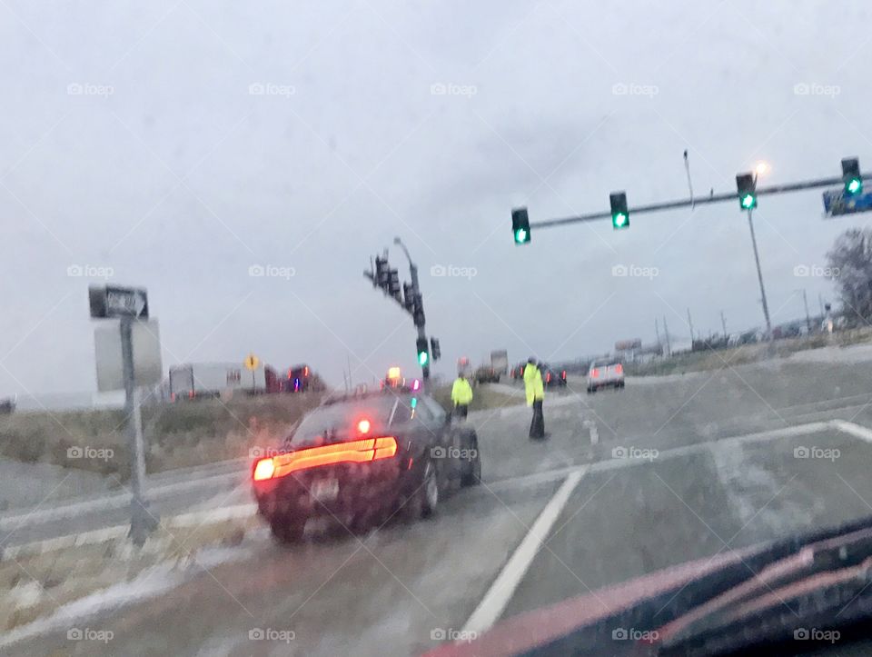 Police, Emergency Responders, Directing Traffic, Exit, Police Car, Lights and Sirens, a traffic Accident, high visibility, red, blue, flashing, traffic lights, green, light, ice, snow, weather, road, bridge, highway, intersection, arrows, lines, pavement, wet, slick, traffic, jam