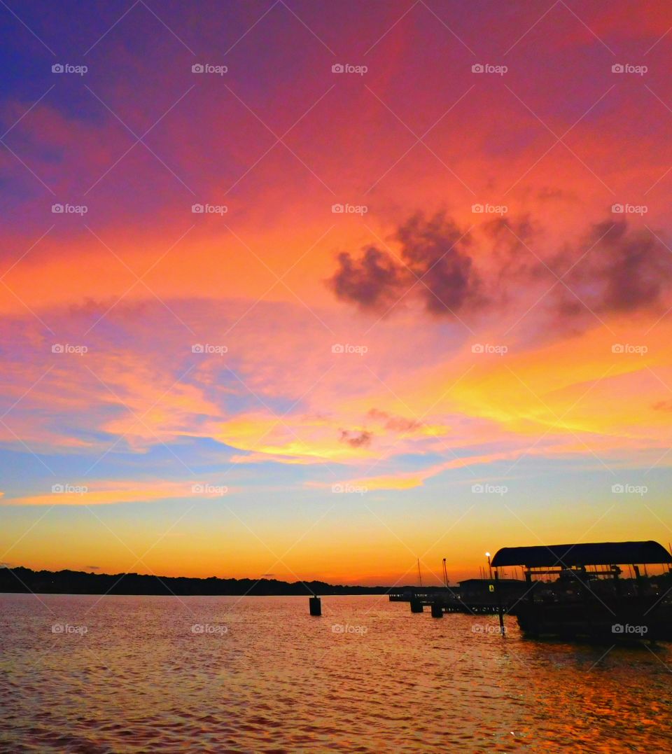  A magnificent pastel, bold, brilliant, and rich colored sunset over the bay as the clouds pass by