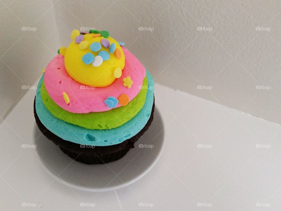 Celebration cupcake, pastel frosting, white background