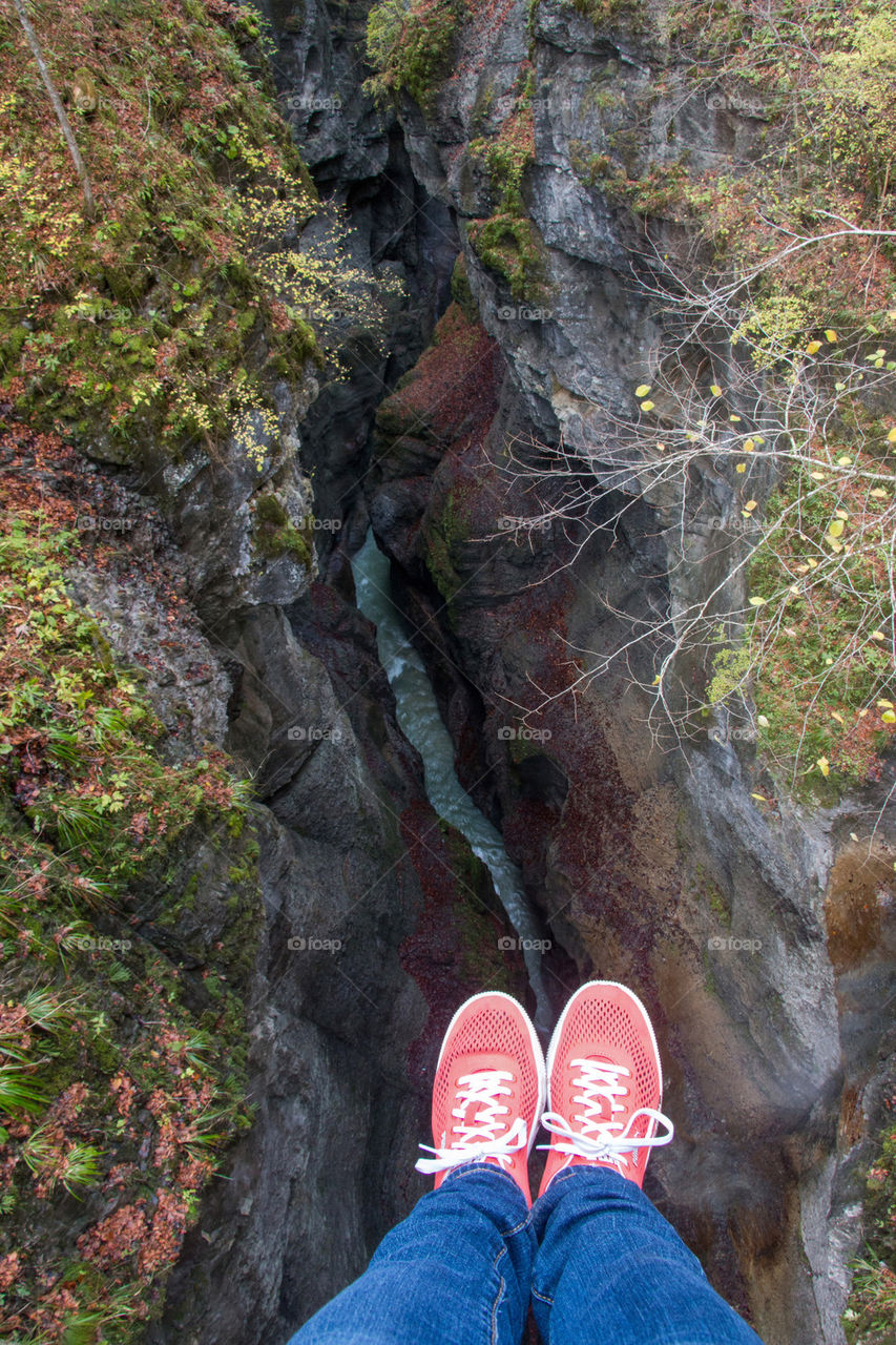 Feet dangling over a gorge 