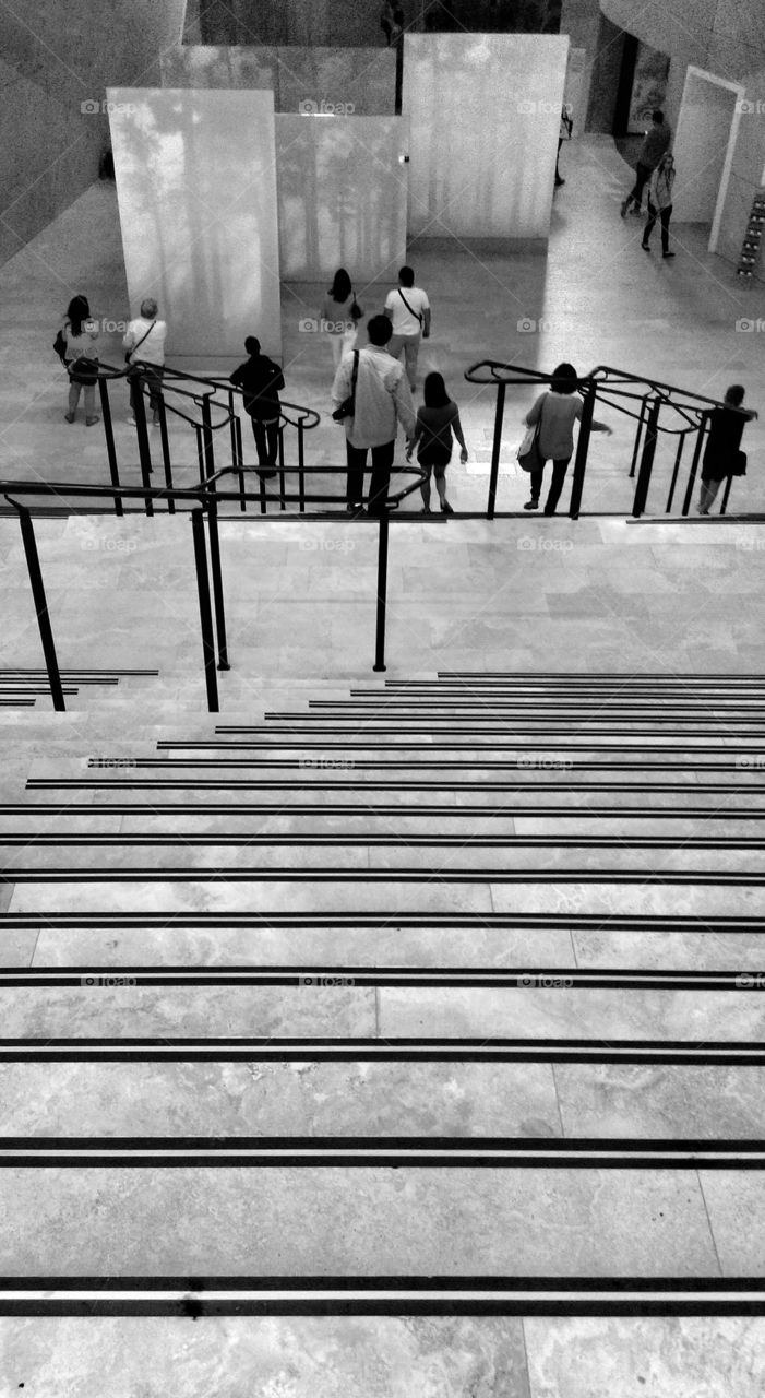 View from stairs at museum. “View of exhibitions from stairs at museum”