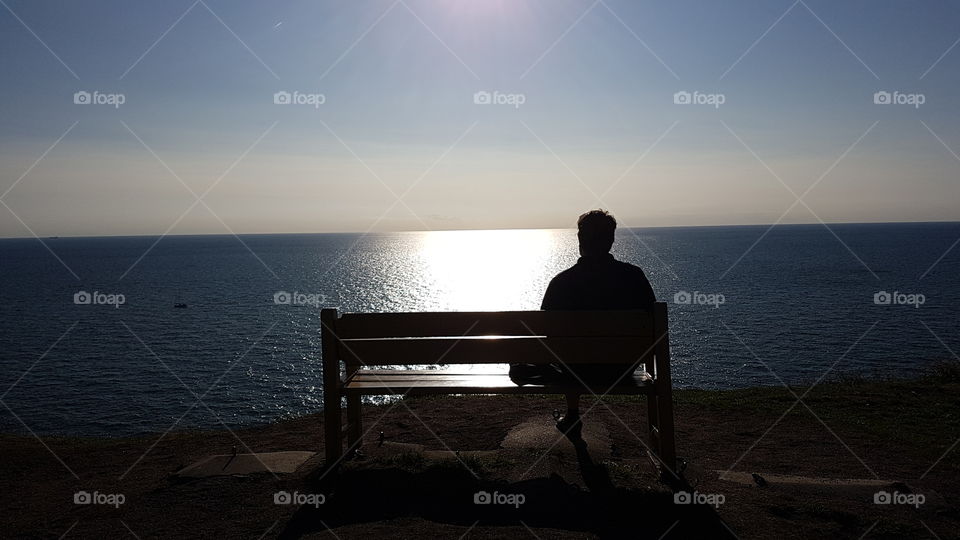 Enjoying the view of the ocean in backlit 