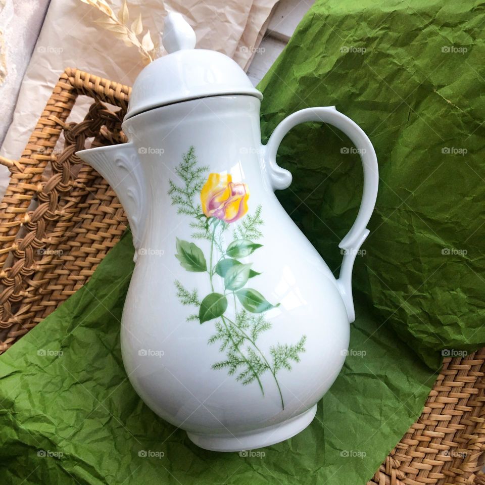 Old porcelain teapot with floral ornaments 