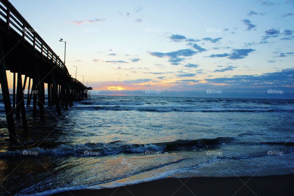 Pier over sea at sunrise