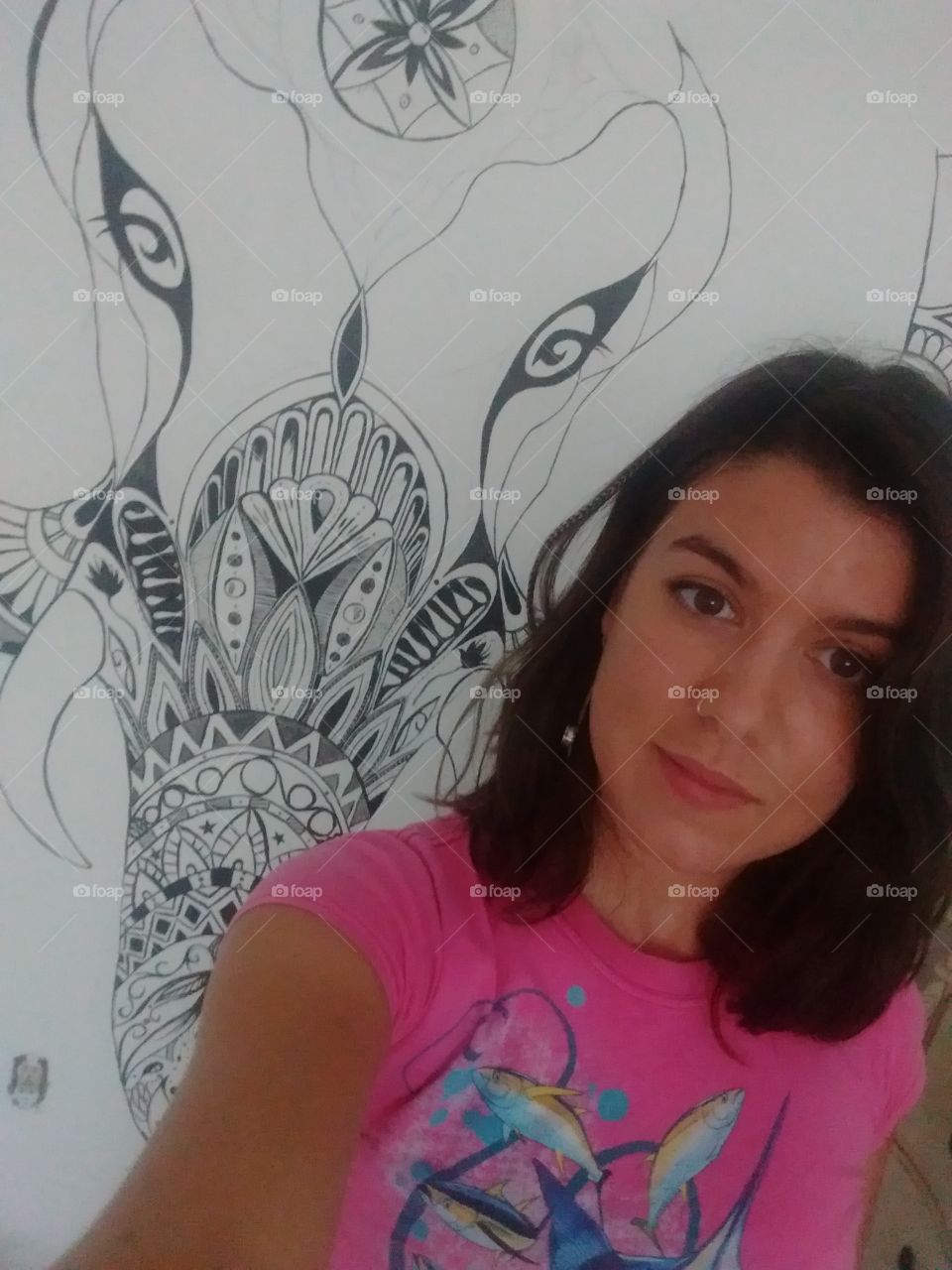 Young female artist takes a picture with her unfinsh work