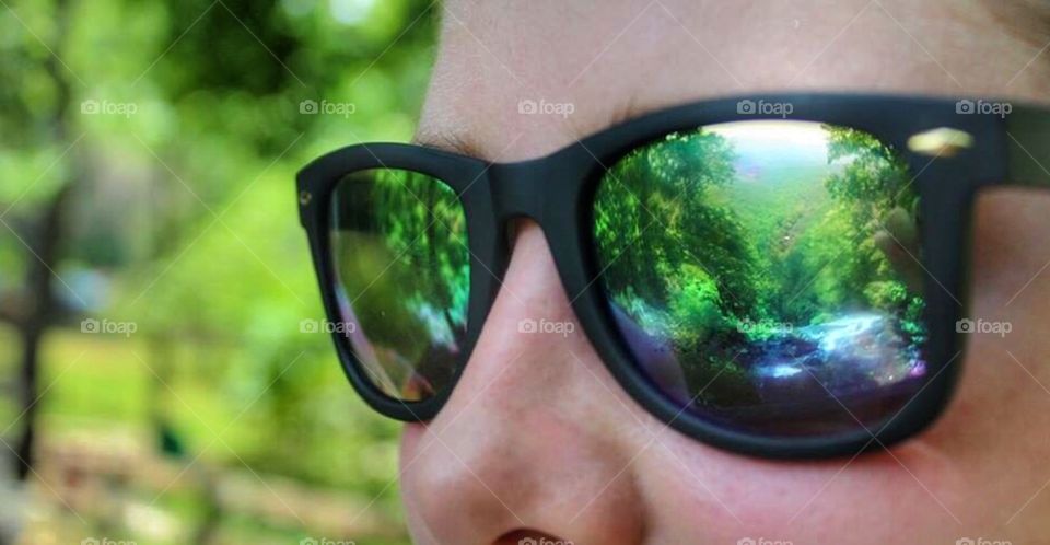 Sunglass reflection. The mountains reflecting in a woman's sunglasses.