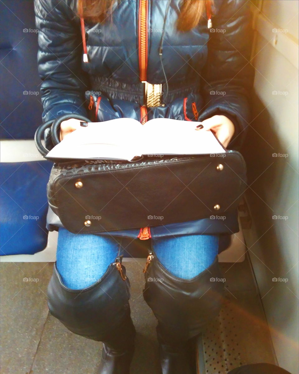 girl reading a book in the transport