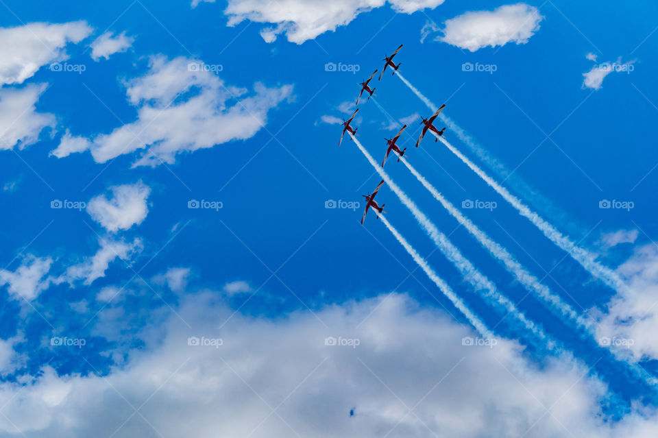 A beautiful airplanes formation in the sky with a bright and fresh background of a cloudy sky