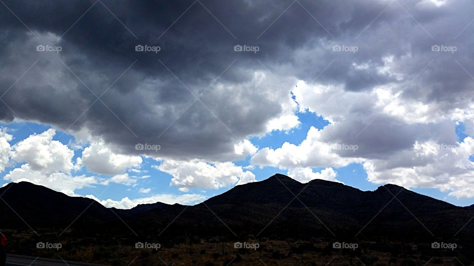 Storm Clouds . Storm clouds over the desert foothills 