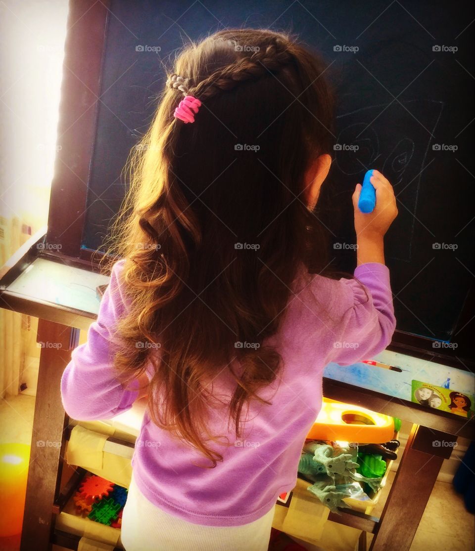 Girl riding on a chalkboard