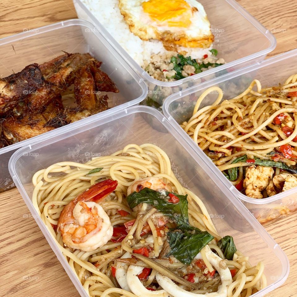 Spicy Thai western fusion meal with noodles , rice and chicken wings 