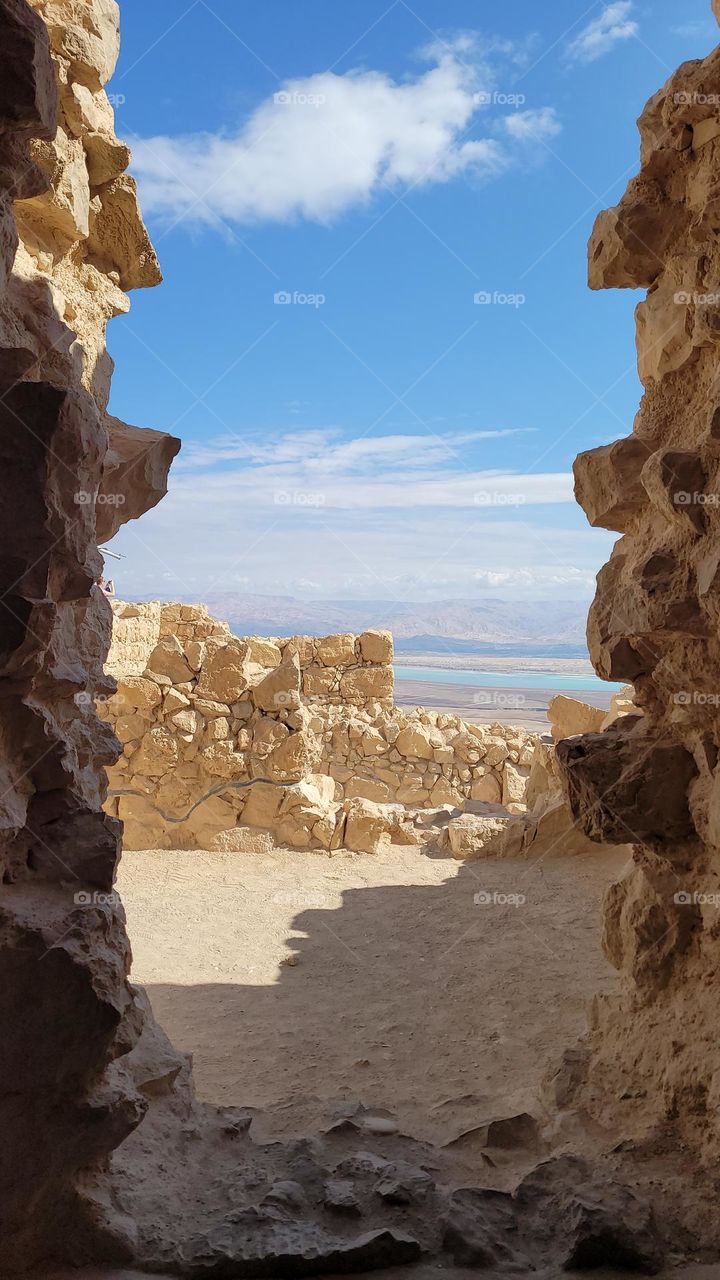 rock window formation in Masada, Israel towards the blue dead sea.