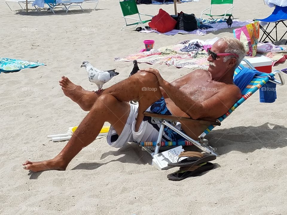 Senior man resting on beach