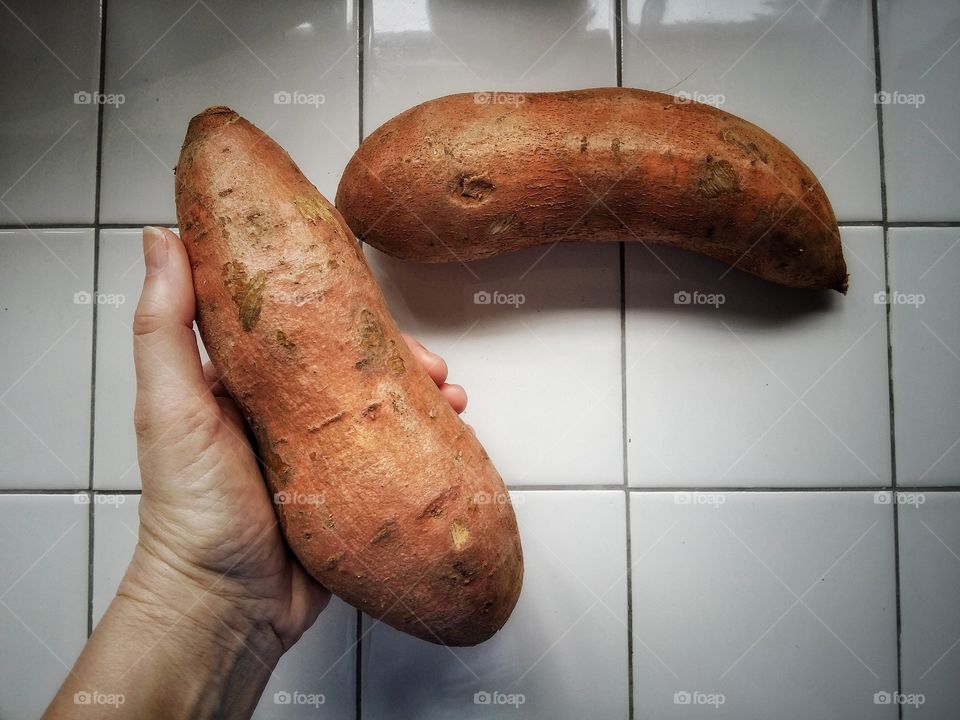 Hand Holding Sweet Potato