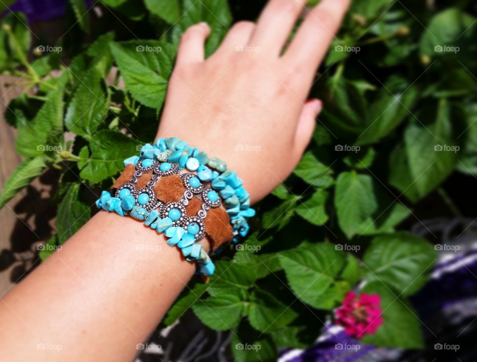 Unique set of bracelets featuring hand strung  turquoise chips  as well as turquoise and silver charms on leather.