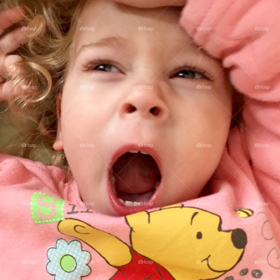 Close-up of a girl yawning