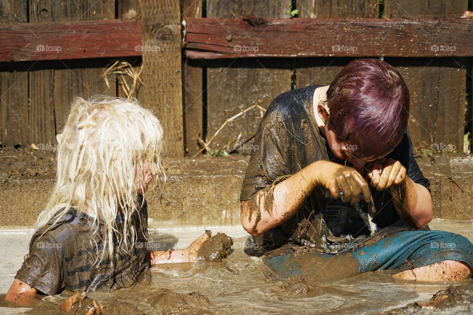 Kids Playing In Mud