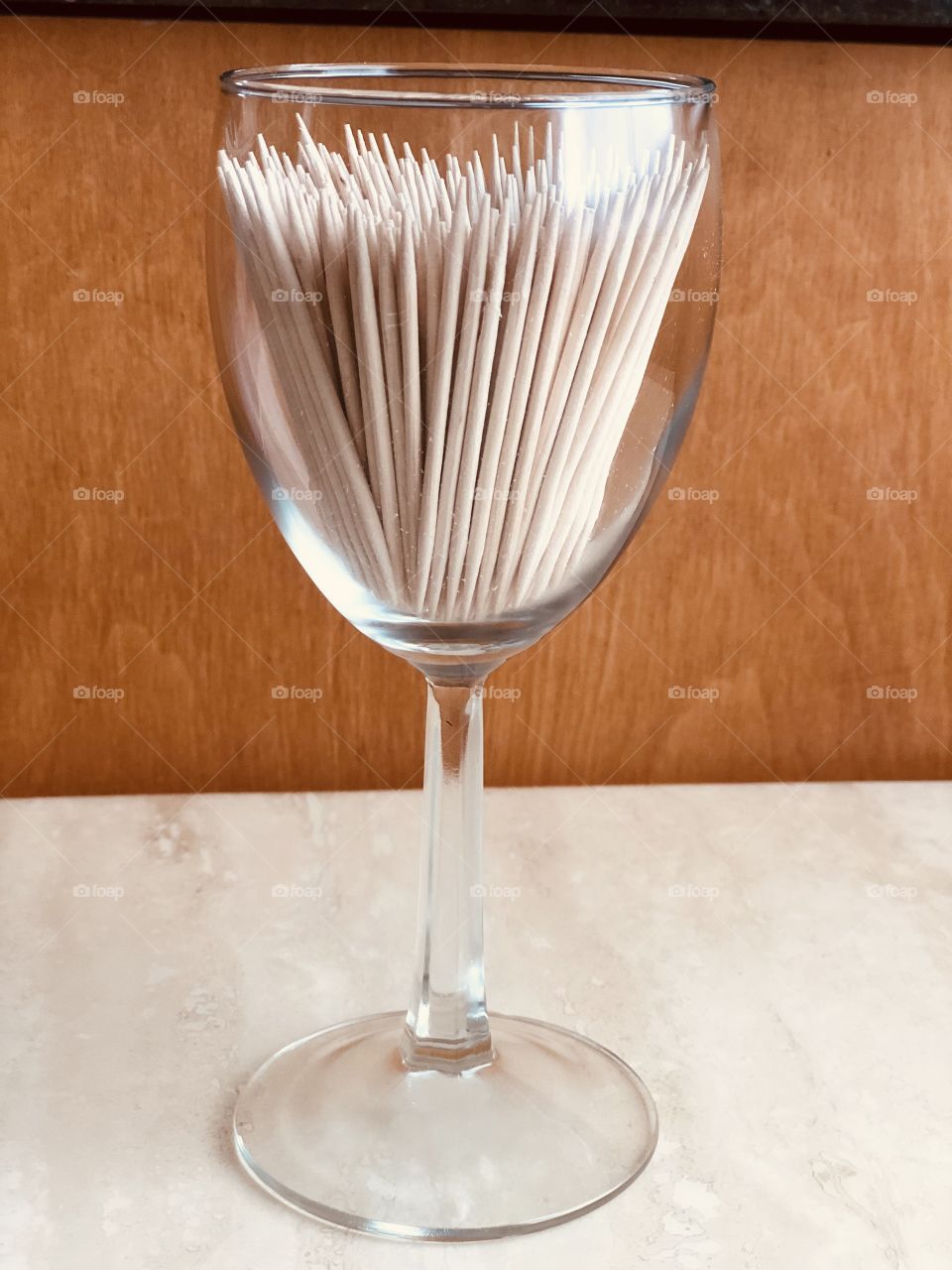 Glass full of toothpicks.