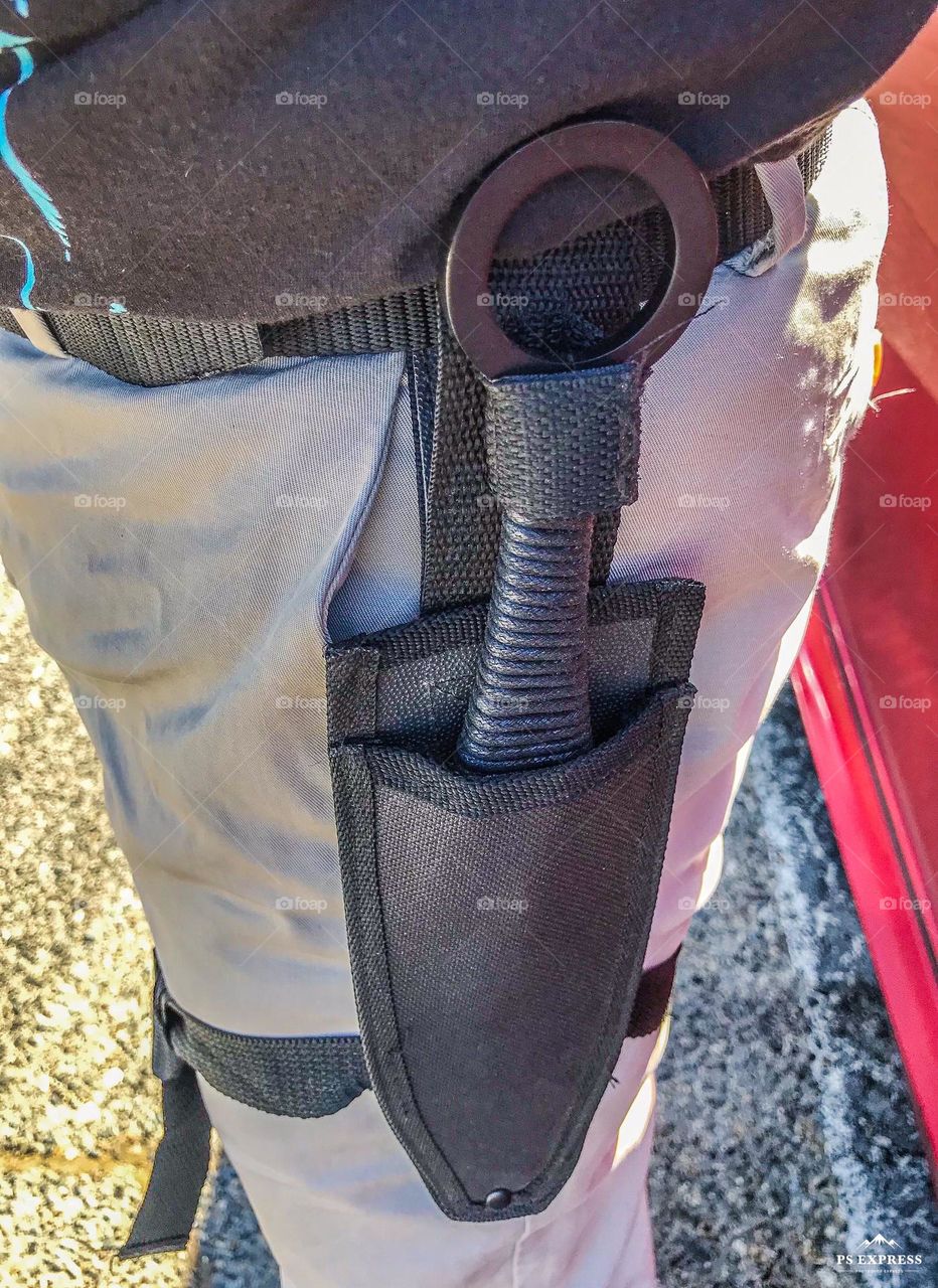 A sheathed kunai worn on a thigh for martial adventure living at the Fresno Pirate Festival.