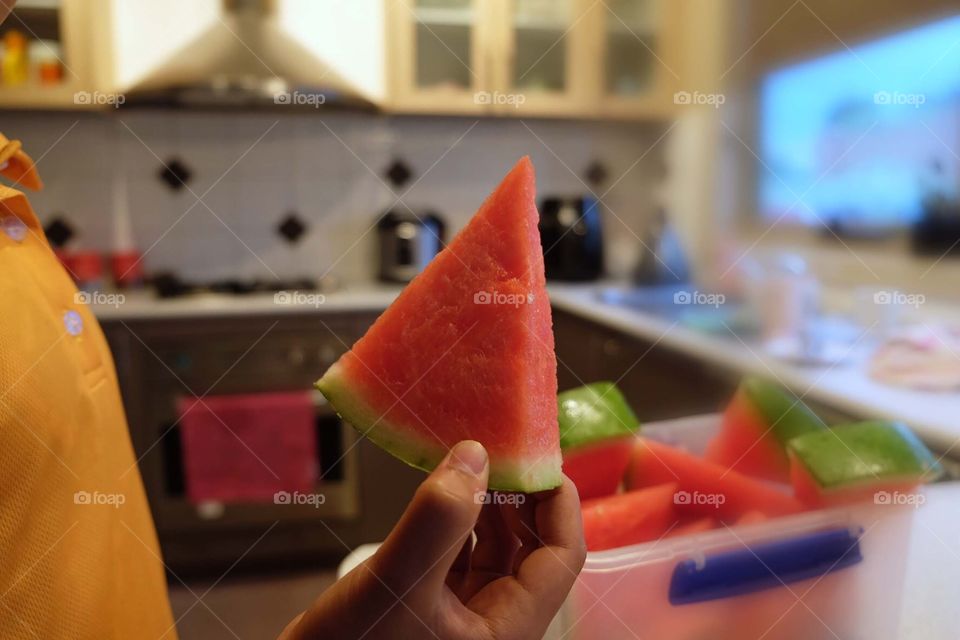 Holding a water melon