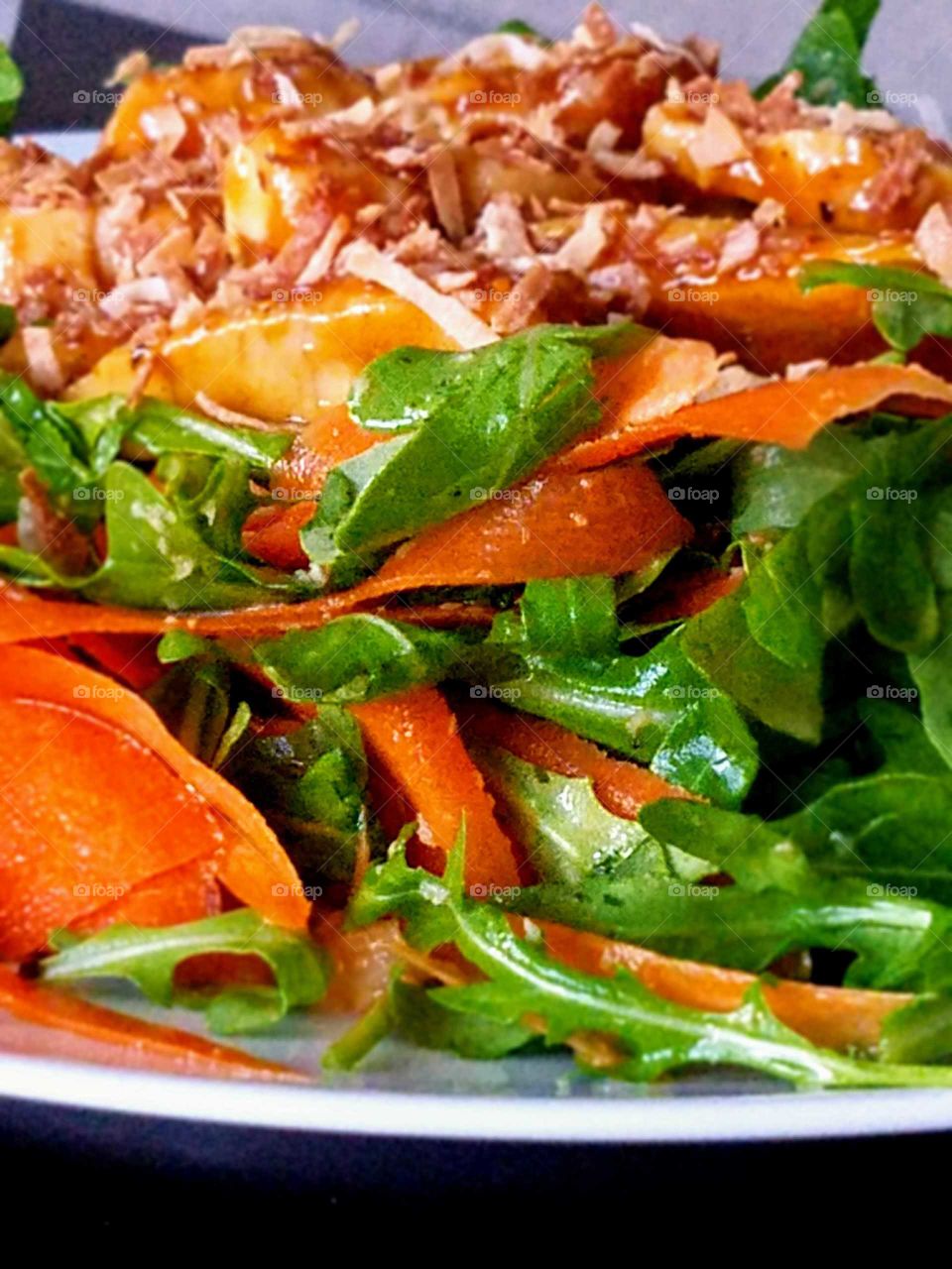 Close-up of meat and arugula in plate