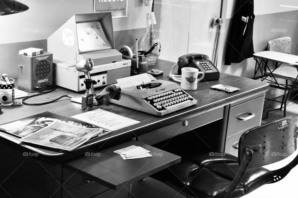 Vintage computer and typewriter at old desk