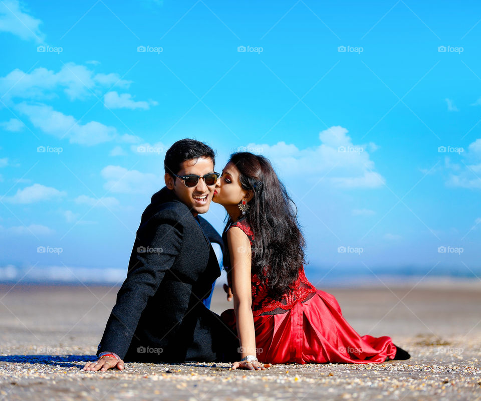 Young woman kissing man on his cheek